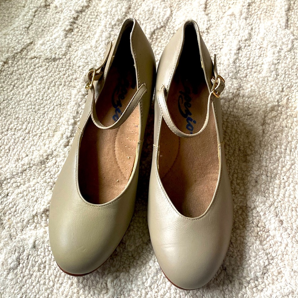 These are beige Capezio Jr. Footlight Character Shoes.